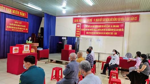 Các cử tri đều được phá t khẩu trang, đo thân nhiệt và giữ khoảng cách chờ đến lượt bỏ phiếu