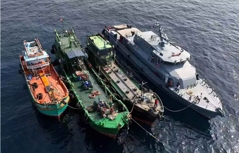 A marine police boat escorts three oil-smuggling ships which had gone missing to the Port of Songkhla early this week. (Photo: Bangkok Post) Thailand probes into missing oil-smuggling ships linked to police force -0