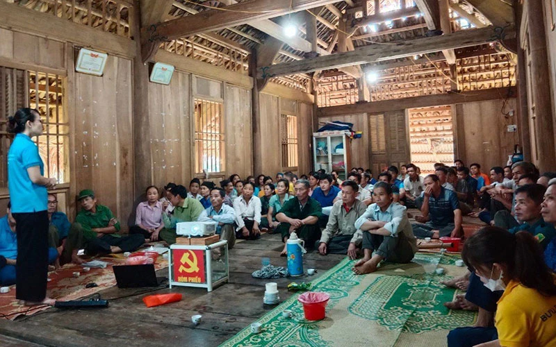 Bà con nghe cán bộ phổ biến chế độ, quyền lợi khi tham gia BHXH. Ảnh: BH