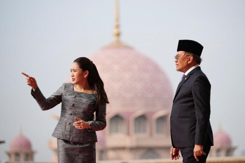 Thai Prime Minister Paetongtarn Shinawatra gestures as she talks with Malaysian Prime Minister Anwar Ibrahim with Putra Mosque in the background during a welcoming ceremony prior to their meeting in Putrajaya on Monday. (Photo: Pool via Reuters) Thai Prime Minister Paetongtarn Shinawatra gestures as she talks with Malaysian Prime Minister Anwar Ibrahim with Putra Mosque in the background during a welcoming ceremony prior to their meeting in Putrajaya on Monday. (Photo: Pool via Reuters)
