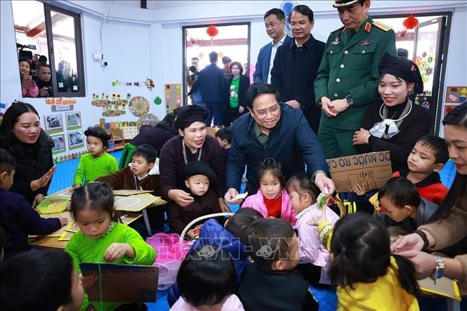 Thủ tướng Phạm Minh Chính thăm trẻ em tại Điểm trường liên cấp mầm non và tiểu học mới của thôn Làng Nủ, xã Phúc Khánh, huyện Bảo Yên, tỉnh Lào Cai được xây dựng bên trong khu tái định cư thôn Làng Nủ. Ảnh: Dương Giang/TTXVN