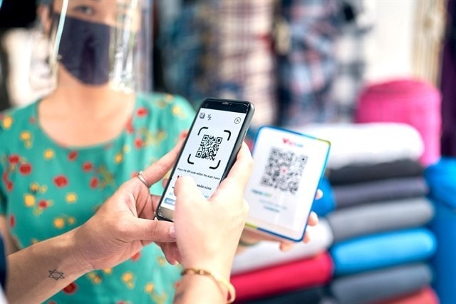 A shopper uses VietQR, a non-cash payment method developed by Napas. — Photo courtesy of Napas A shopper uses VietQR, a non-cash payment method developed by Napas. — Photo courtesy of Napas