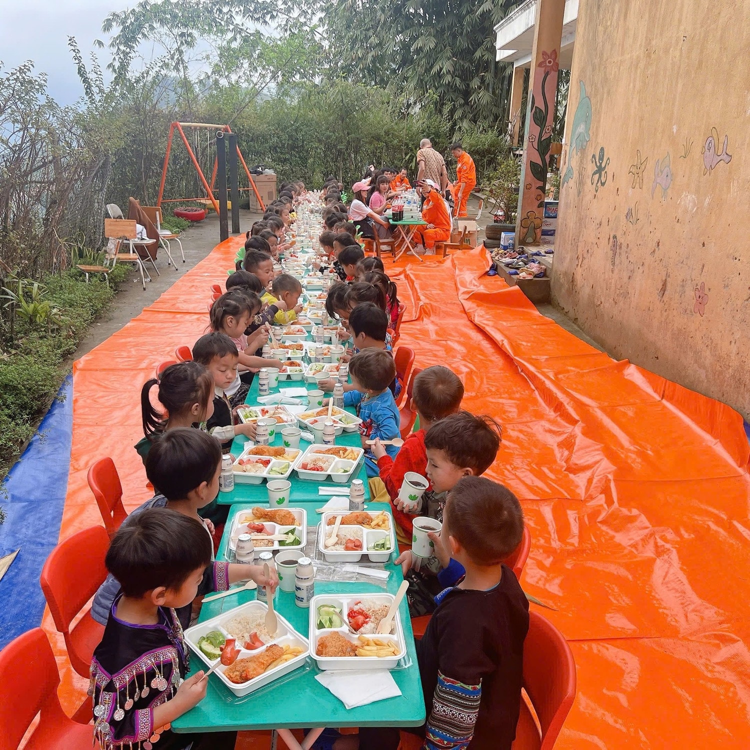 cac-hoc-sinh-cac-co-giao-va-cac-co-chu-tinh-nguyen-vien-cung-thuong-thuc-bua-an-trua-do-chinh-tay-cac-cbcnv-cong-ty-nedi3-chuan-bi-trong-khung-canh-thanh-binh-cua-nui-rung-tay-bac-mua-xuan.jpg
