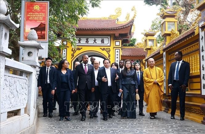 Thủ tướng Phạm Minh Chính và Phu nhân cùng Thủ tướng Ethiopia Abiy Ahmed Ali và Phu nhân nghe giới thiệu về văn hoá, lịch sử, kiến trúc chùa Trấn Quốc. Ảnh: Dương Giang/TTXVN