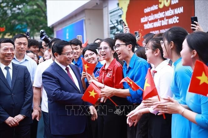 Thủ tướng Phạm Minh Chính với sinh viên tham dự Lễ phát động Phong trào “Cả nước thi đua đổi mới sáng tạo và chuyển đổi số”. Ảnh: Dương Giang/TTXVN.