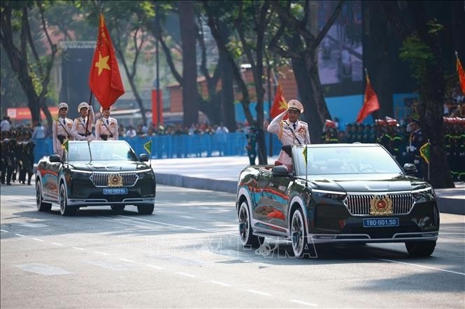 Xe chỉ huy và xe Tổ Công an kỳ - lực lượng công an nhân dân tiến qua lễ đài. Ảnh: TTXVN