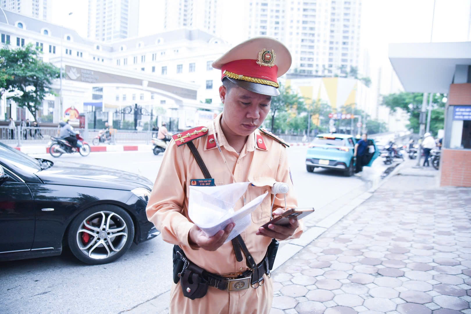 Sáng nay ghi nhận 1 trường hợp không chỉ đến nhầm điểm thi, mà còn luống cuống đánh rơi cả phiếu dự thi. Lực lượng công an hỗ trợ vận chuyển phiếu dự thi đến điểm THCS Trần Duy Hưng cho thí sinh đó. Ảnh: Xuân Quý