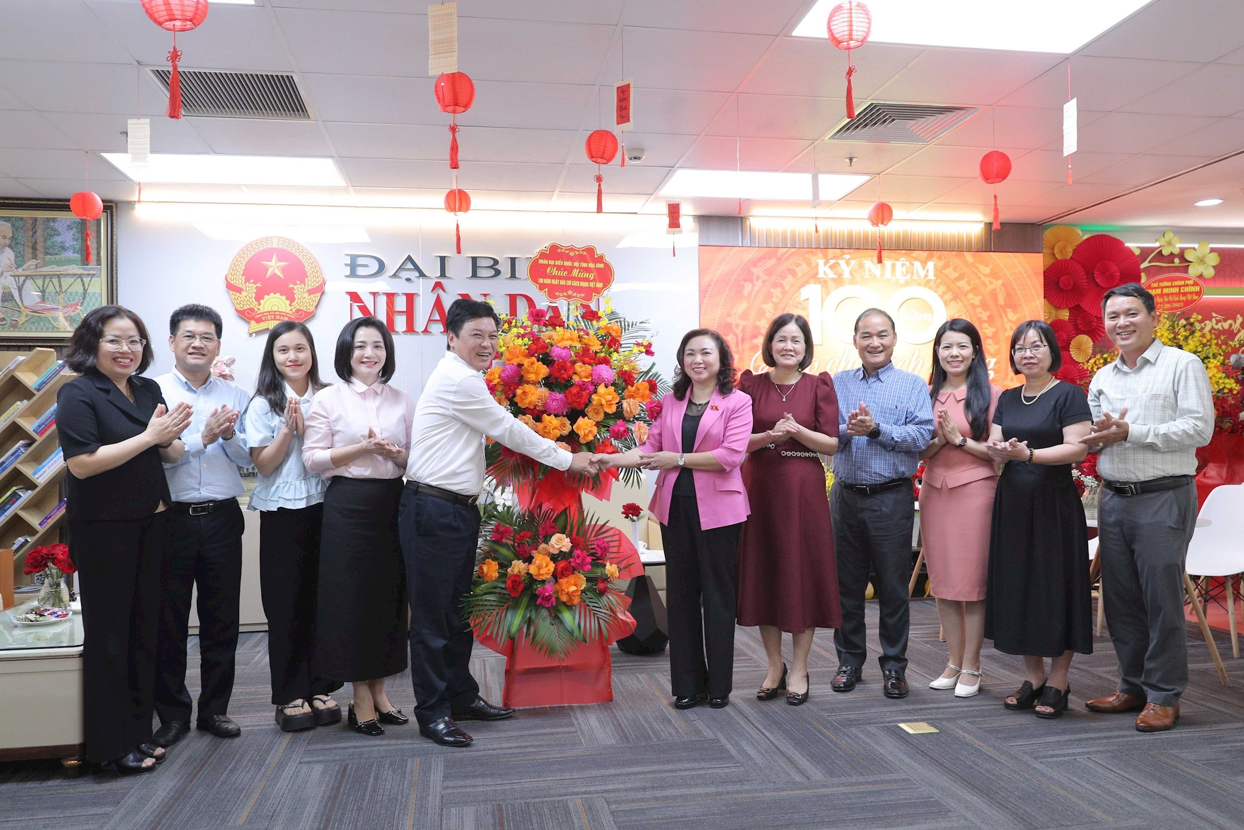 Phó Trưởng Đoàn chuyên trách phụ trách Đoàn đại biểu Quốc hội tỉnh Hòa Bình Đặng Bích Ngọc tặng lẵng hoa cho báo ĐBND