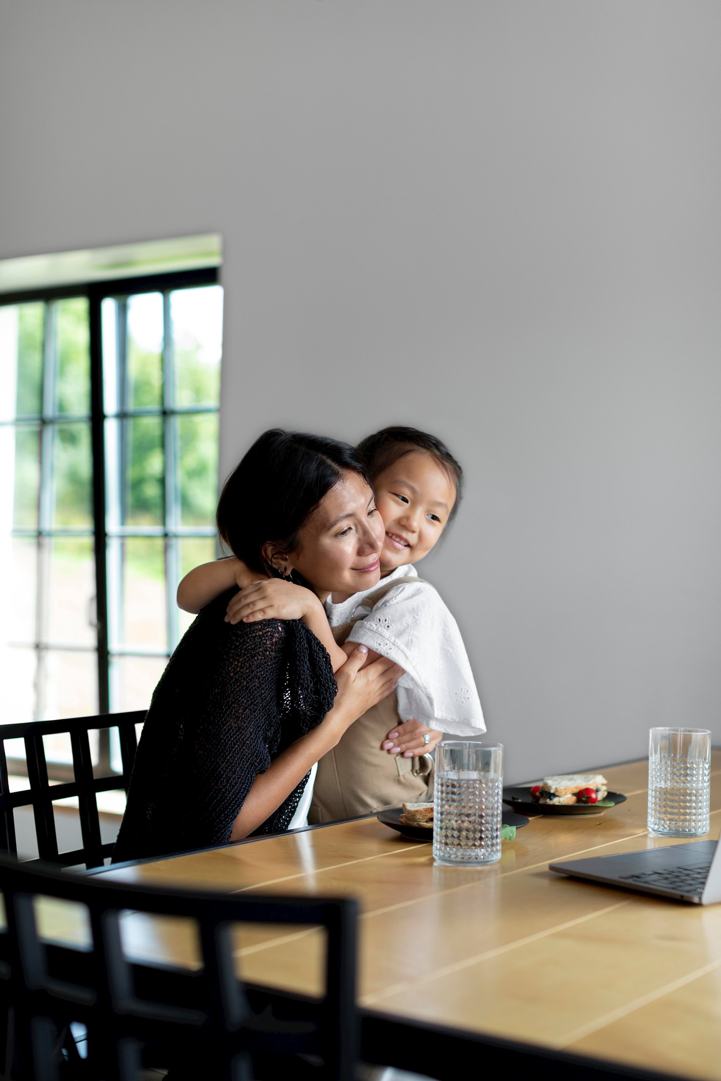 woman-having-video-call-with-her-husband-their-daughter-indoors.jpg