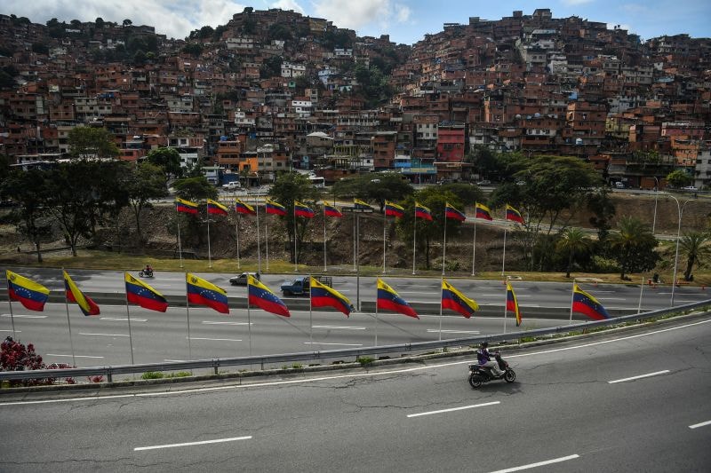 A man rides on the Cacique Guaicaipuro highway after the capture of Nicolas Maduro by US forces, on January 7 in Caracas, Venezuela.
