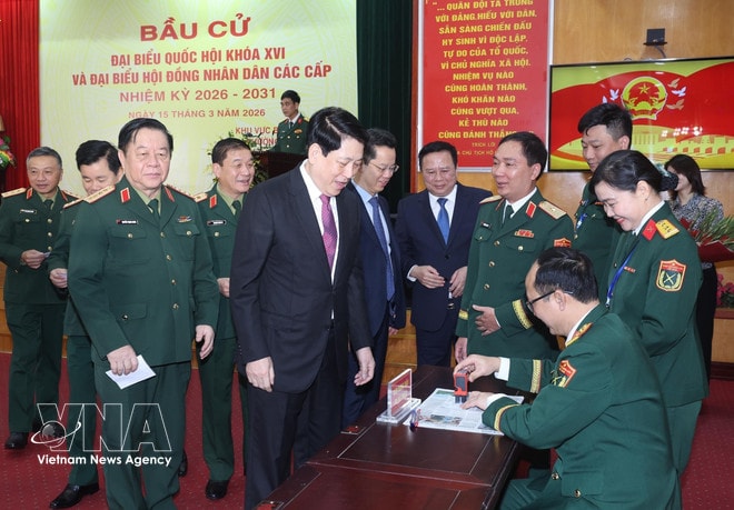 State President Luong Cuong receives his voter card with a confimation seal after casting his ballot at Polling Station No. 26 in Hoan Kiem ward, Hanoi, on the morning of March 15. (Photo: VNA) vnanet-president-luong-cuong-casts-ballot-in-hoan-kien-ward-2.jpg