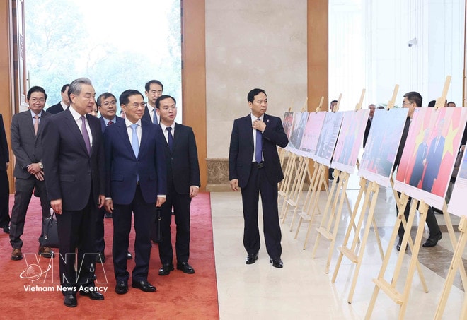 Deputy Prime Minister Bui Thanh Son and Chinese Foreign Minister Wang Yi view a photo exhibition on Vietnam–China relations held by the Vietnam News Agency. (Photo: VNA) vnanet-photo.jpg