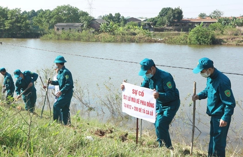 Lực lượng xung kích phòng, chống thiên tai thực hành kỹ năng xử lý sự cố sạt lở mái đê tả sông Cà Lồ. Ảnh HNM