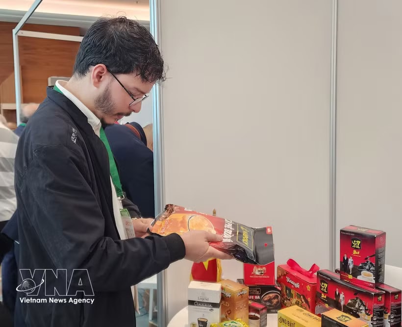 A visitor is interested in Vietnamese coffee showcased on the sidelines of the 12th Africa Forum for Investment and Commerce. (Photo: VNA)