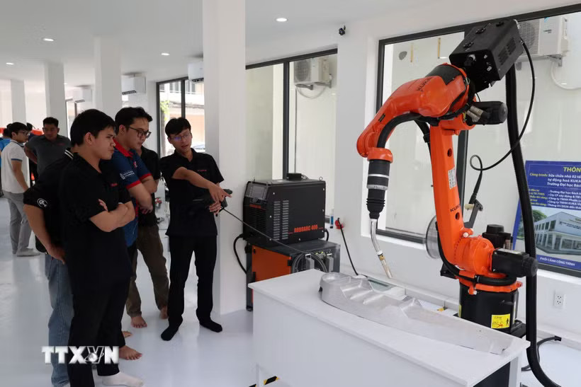 Thử nghiệm robot công nghiệp tại Trung tâm Đào tạo, Nghiên cứu và Phát triển Ứng dụng Robot Công nghiệp và Trí tuệ nhân tạo (Trường Đại học Bách khoa-Đại học Đà Nẵng). (Ảnh: Khoa Chương/TTXVN)
