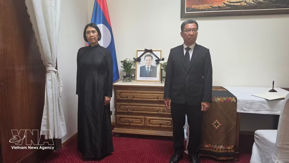 Vietnamese Ambassador to Belgium and Permanent Representative of Vietnam to the European Union (EU) Nguyen Huong Tra (left) pays tribute to Xaysomphone Phomvihane, Politburo member and President of the Lao National Assembly (Photo: VNA) vnanet-su-quan2.jpg