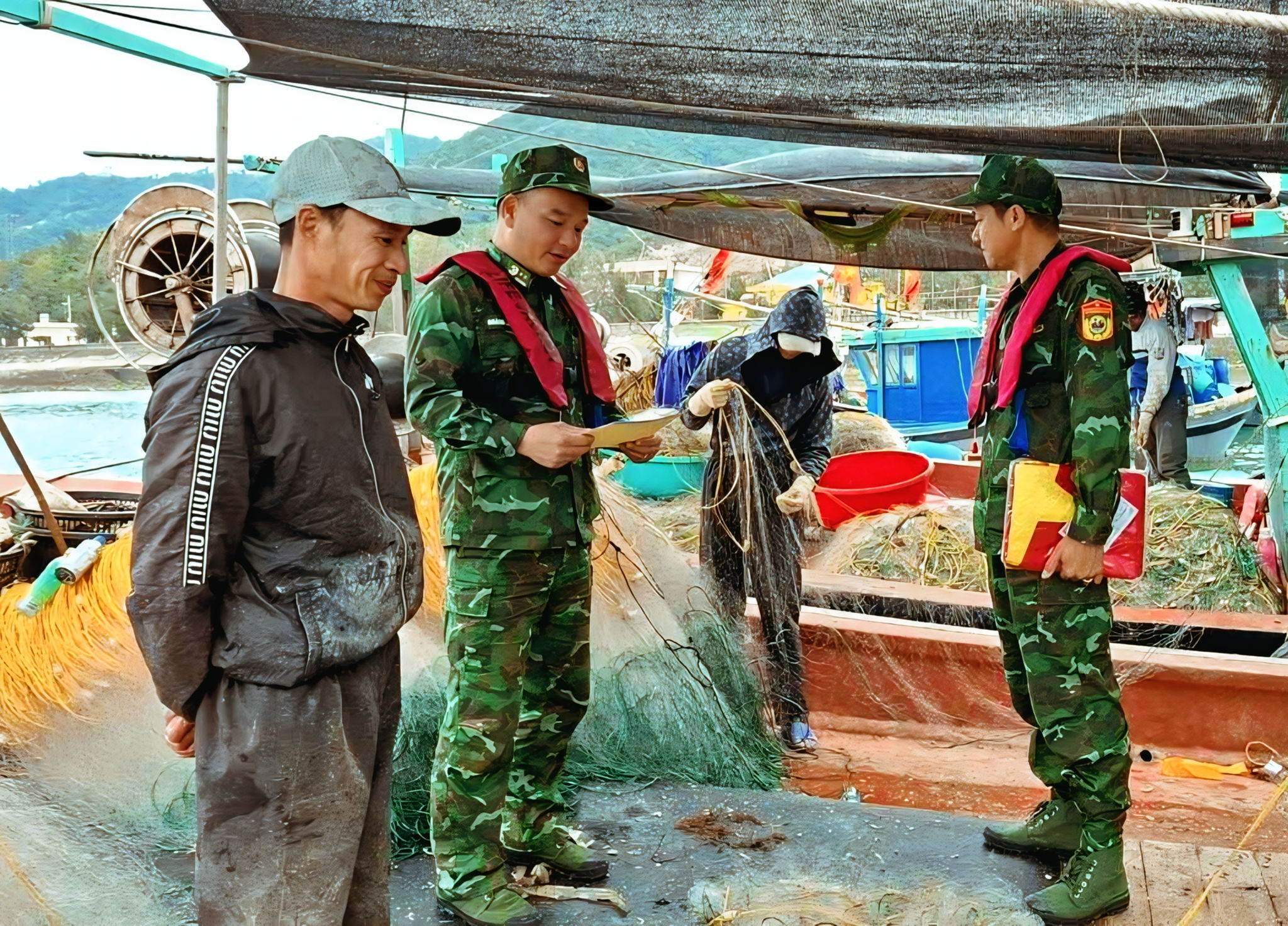 Cán bộ, chiến sĩ Đồn Biên phòng đảo Trần tuyên truyền cho ngư dân các quy định về khai thác thuỷ sản
