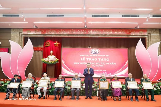 Party, State leader presents Party-membership badges to veteran members